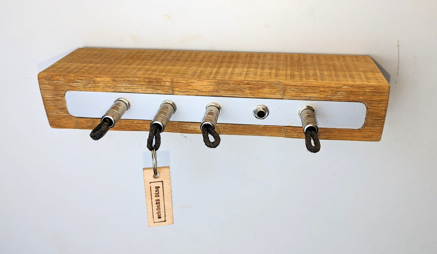 Schlüsselboard aus Holz mit Klinkenstecker.
Der Klinkenstecker kommt einfach an den Ring des Schlüssels. Mit einem „click“ steckt er im Board und kann so beim Gehen auch wieder herausgezogen werden.
So einfach kann Ordnung sein!
Und weil es Spaß macht, macht ihr es auch (ja, auch die Person, von der ihr gerade denkt: „Never, der nicht!“).
Nie wieder den Schlüssel suchen.