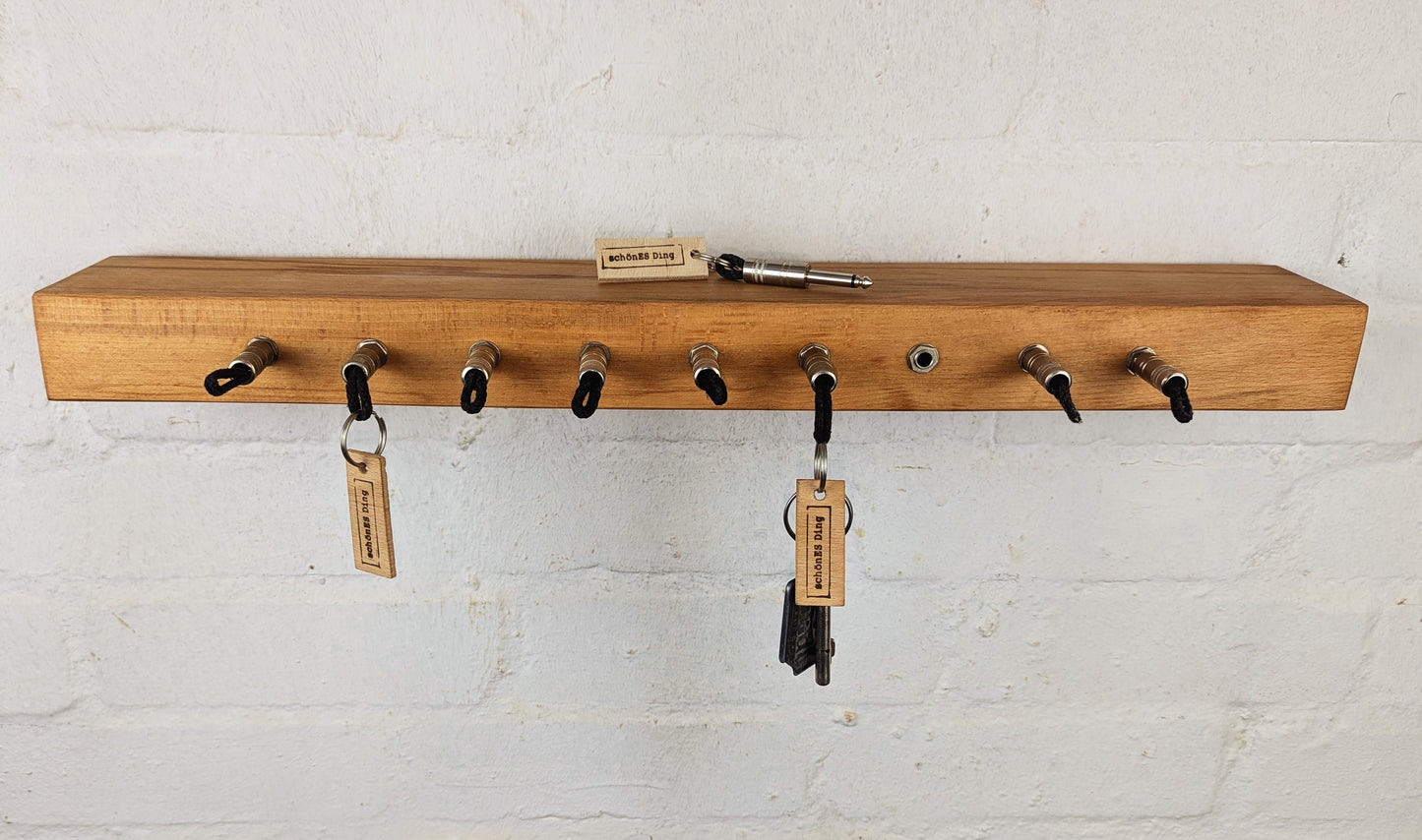 Board ist aus 5cm Buchenbohle, in die die Buchsen integriert sind.
Das Holz ist geschliffen und geölt.
Platz für 9 Schlüssel.
Auf der Rückseite befindet die die Wandaufhängung. Zwei Schrauben in die Wand, einhaken, fertig.