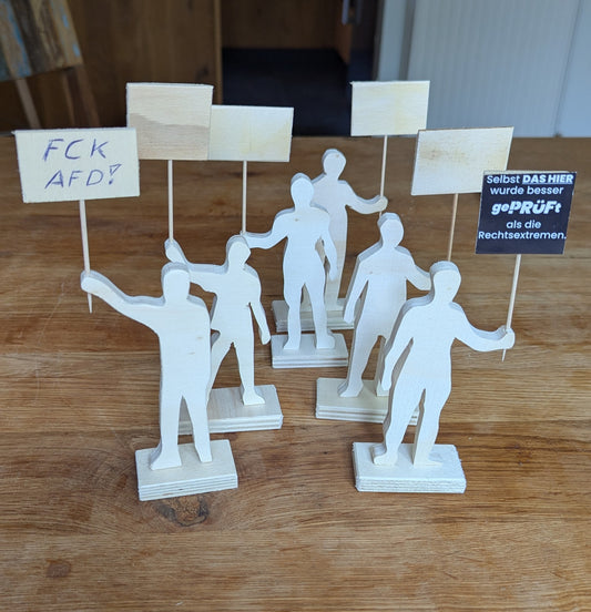 Demonstranten aus Holz. Plakate zum selbst gestalten